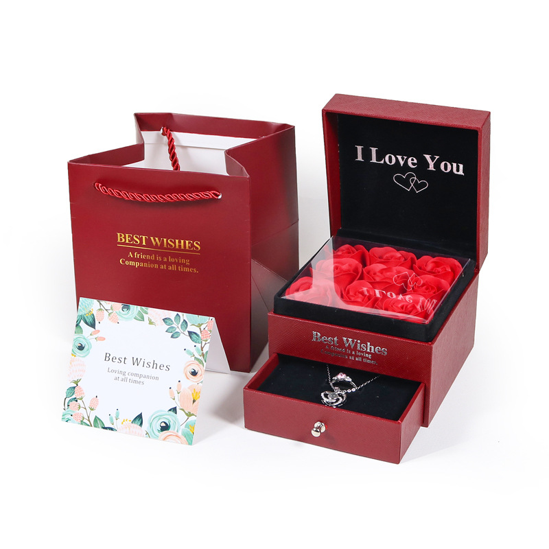 An I Love You rose box with its lower drawer pulled out to show the necklace inside